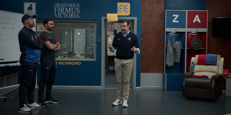 Nike Air Zoom Sneakers of Jason Sudeikis, New Balance Shoes of Brendan Hunt as Coach Beard, Nike Black Sneakers and Clothes of Brett Goldstein as Roy Kent in Ted Lasso S03E05 “Signs” (2023)